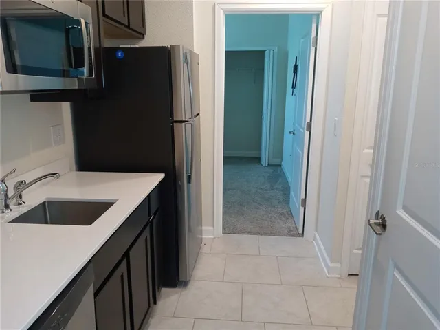 a kitchen with a sink and refrigerator