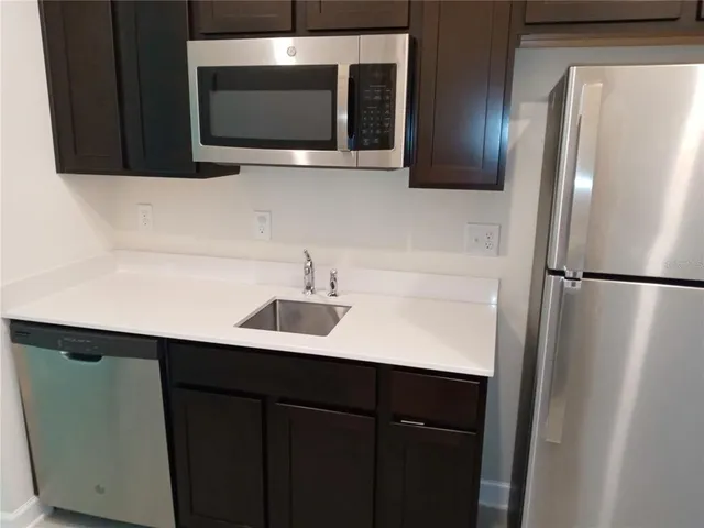 a kitchen with a sink and a microwave