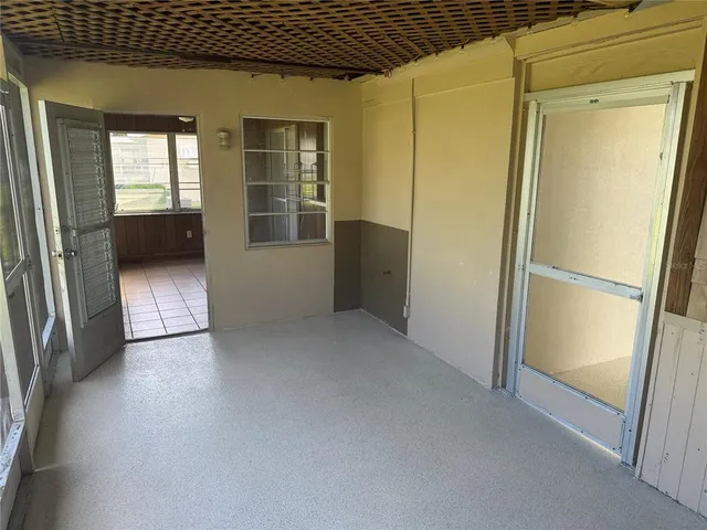 a view of empty room with wooden floor and cabinet