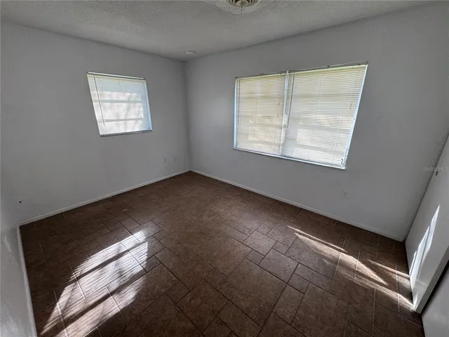 a view of empty room with window and fireplace