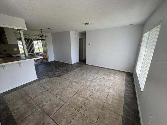 a view of a livingroom with furniture wooden floor and flat screen tv