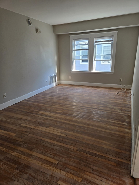 654 Metropolitan Avenue, Unit 4 Boston, MA 02136 - Photo 11 of 16 wooden floor in an empty room with a window