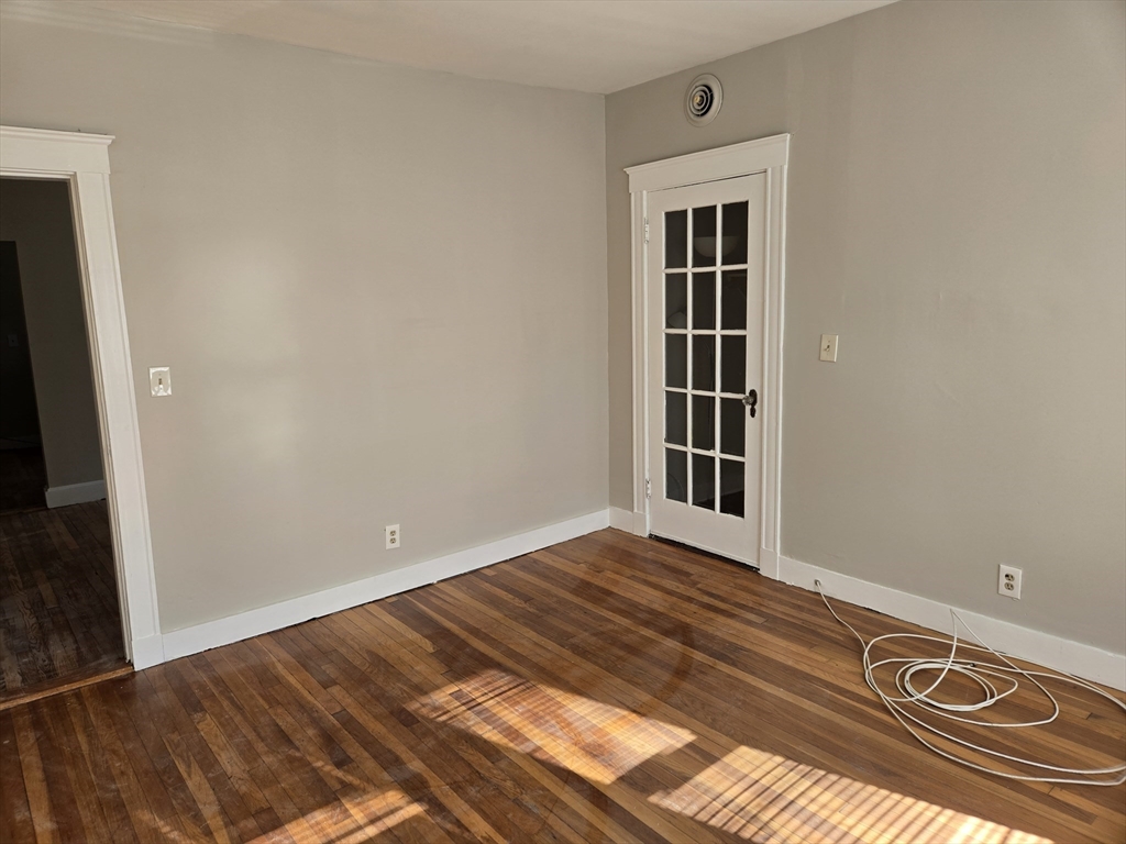 654 Metropolitan Avenue, Unit 4 Boston, MA 02136 - Photo 9 of 16 a view of a livingroom with wooden floor
