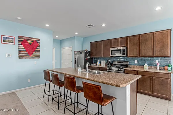 a kitchen with granite countertop a sink and a wooden floor