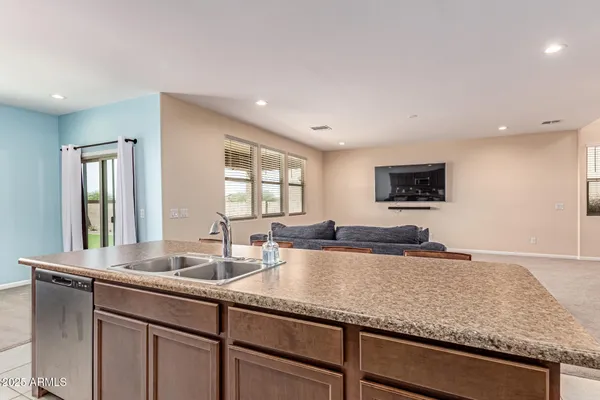 a kitchen with stainless steel appliances granite countertop a sink and a refrigerator