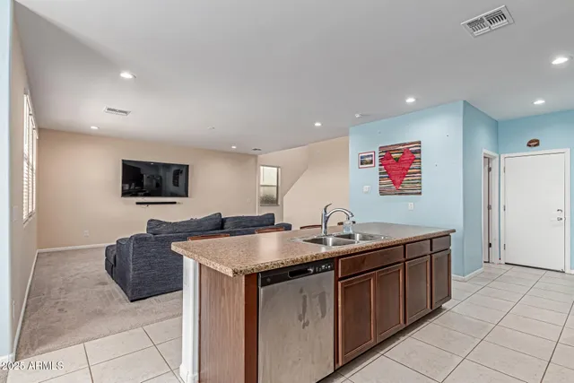 a bathroom with a granite countertop toilet sink and mirror