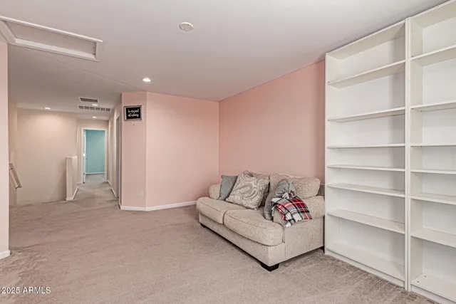 a spacious bedroom with a bed and a cabinets