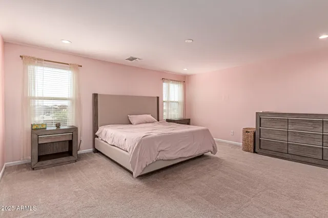 a large bed in a white room