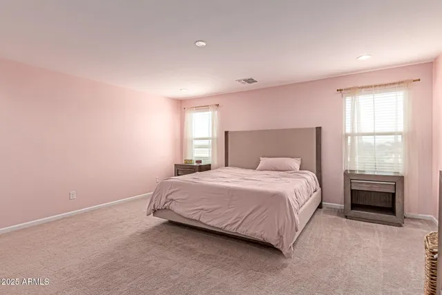 a bathroom with a granite countertop double vanity sink and a mirror