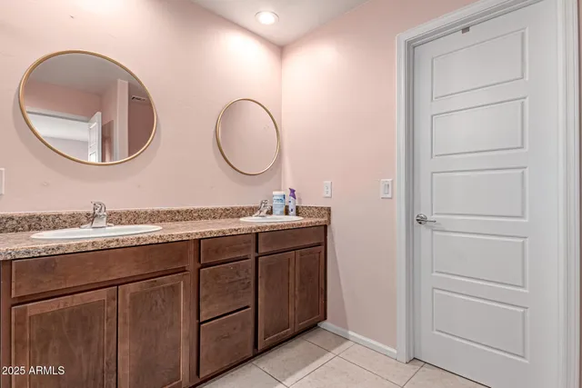 a bathroom with a granite countertop sink a mirror and a shower