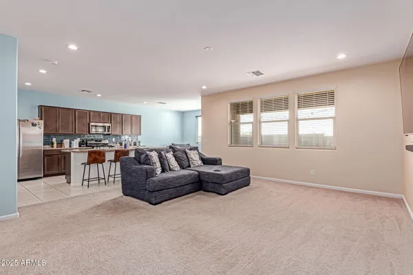 a living room with furniture and kitchen view