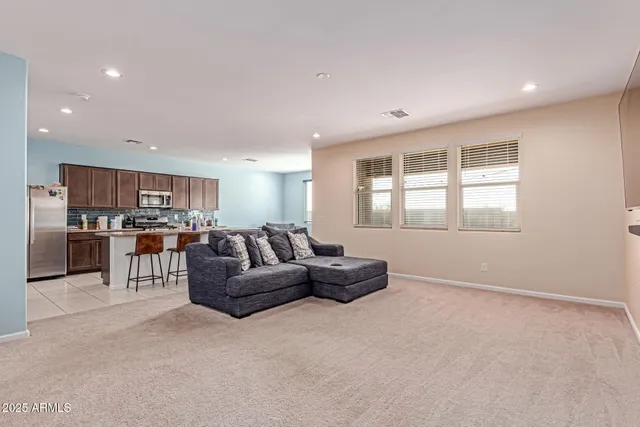 a living room with furniture and kitchen view