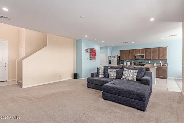 a living room with couches and a flat screen tv
