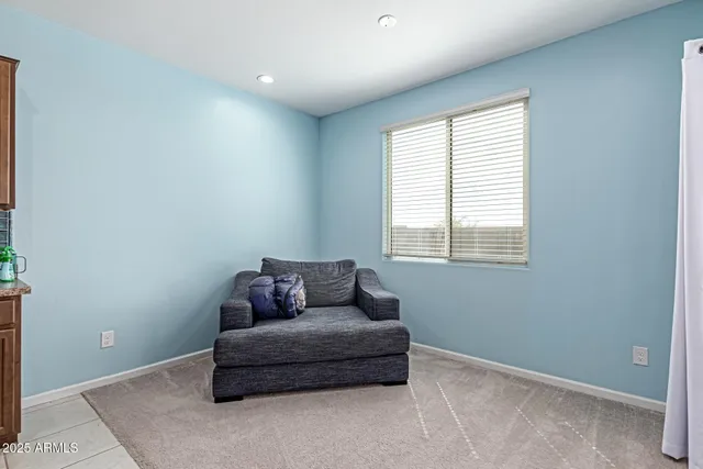 a kitchen with stainless steel appliances granite countertop a table chairs sink refrigerator and cabinets