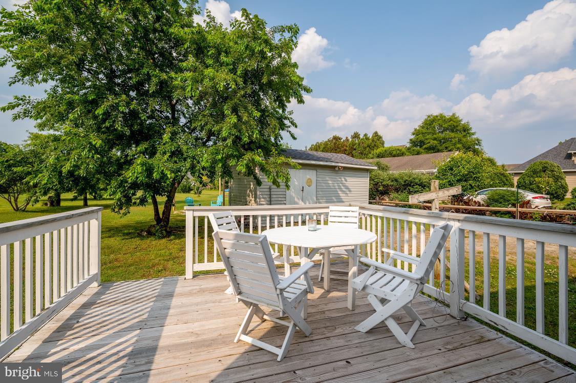 32789 Cedar Drive Ocean View, DE 19970 - Photo 16 of 18 a view of a deck with chair and wooden floor