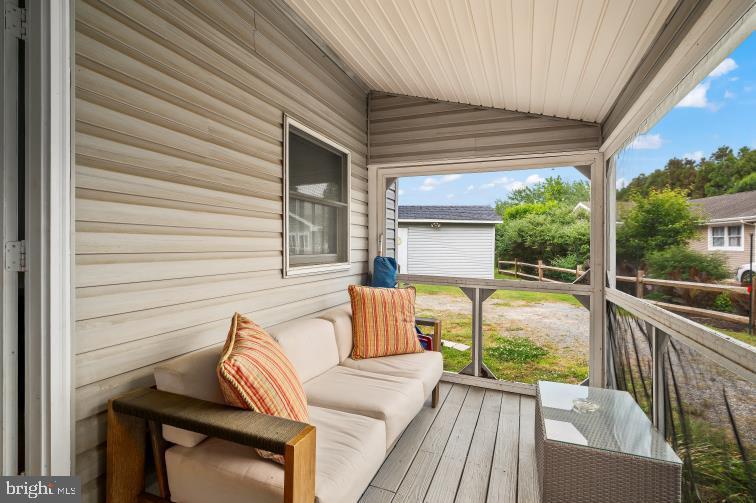 32789 Cedar Drive Ocean View, DE 19970 - Photo 3 of 18 a view of a patio with couches chairs and wooden floor