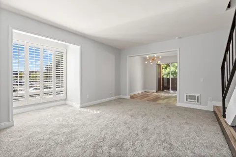 an empty room with windows and closet
