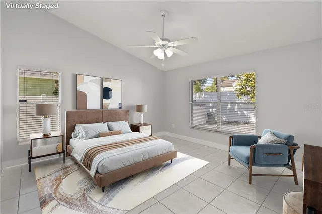 an empty room with windows and ceiling fan