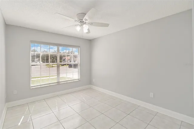an empty room with fan and entryway