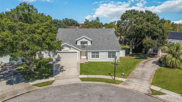 an aerial view of a house with a garden and trees