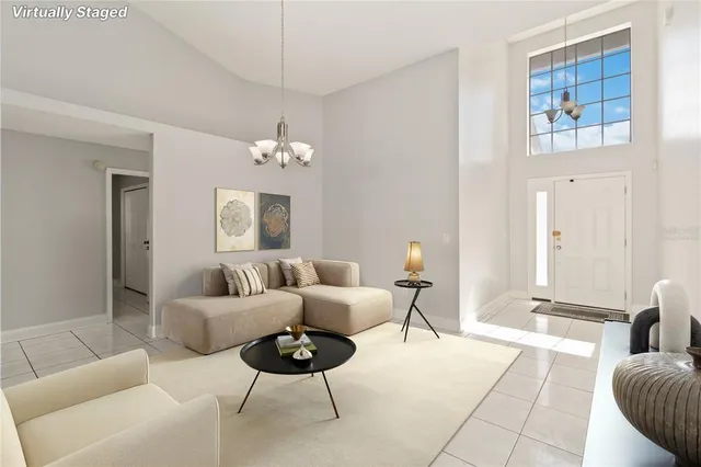 a living room with furniture and a chandelier