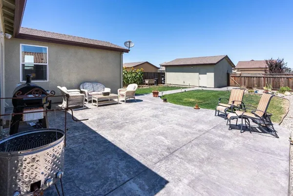 a backyard of a house with outdoor seating