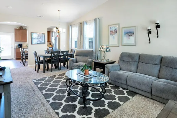 a living room with furniture and wooden floor