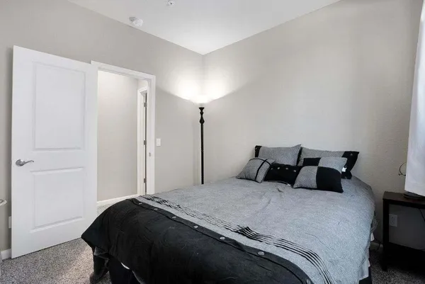 a bedroom with a bed and a night stand