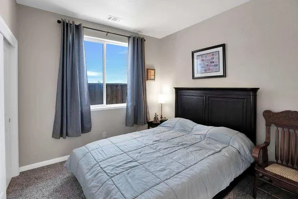 a bedroom with a bed and a large mirror