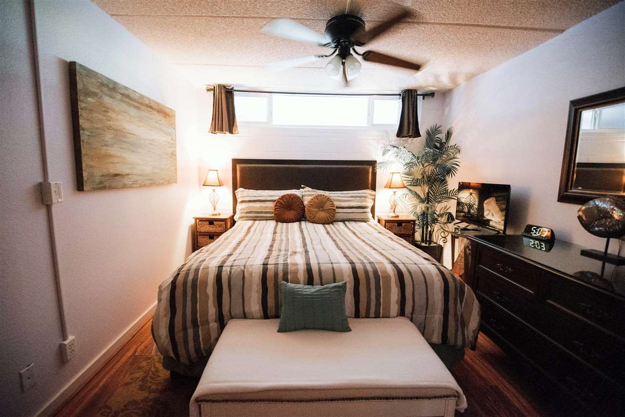 2531 South Kihei Road, Unit D210 Kihei, HI 96753 - Photo 11 of 23 a bedroom with a bed a couch and potted plant on the dresser
