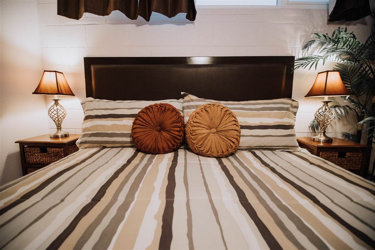 2531 South Kihei Road, Unit D210 Kihei, HI 96753 - Photo 13 of 23 a bedroom with a bed and wooden floor