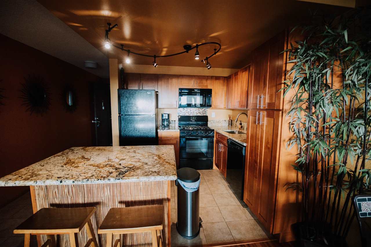 2531 South Kihei Road, Unit D210 Kihei, HI 96753 - Photo 4 of 23 a kitchen with refrigerator and chairs