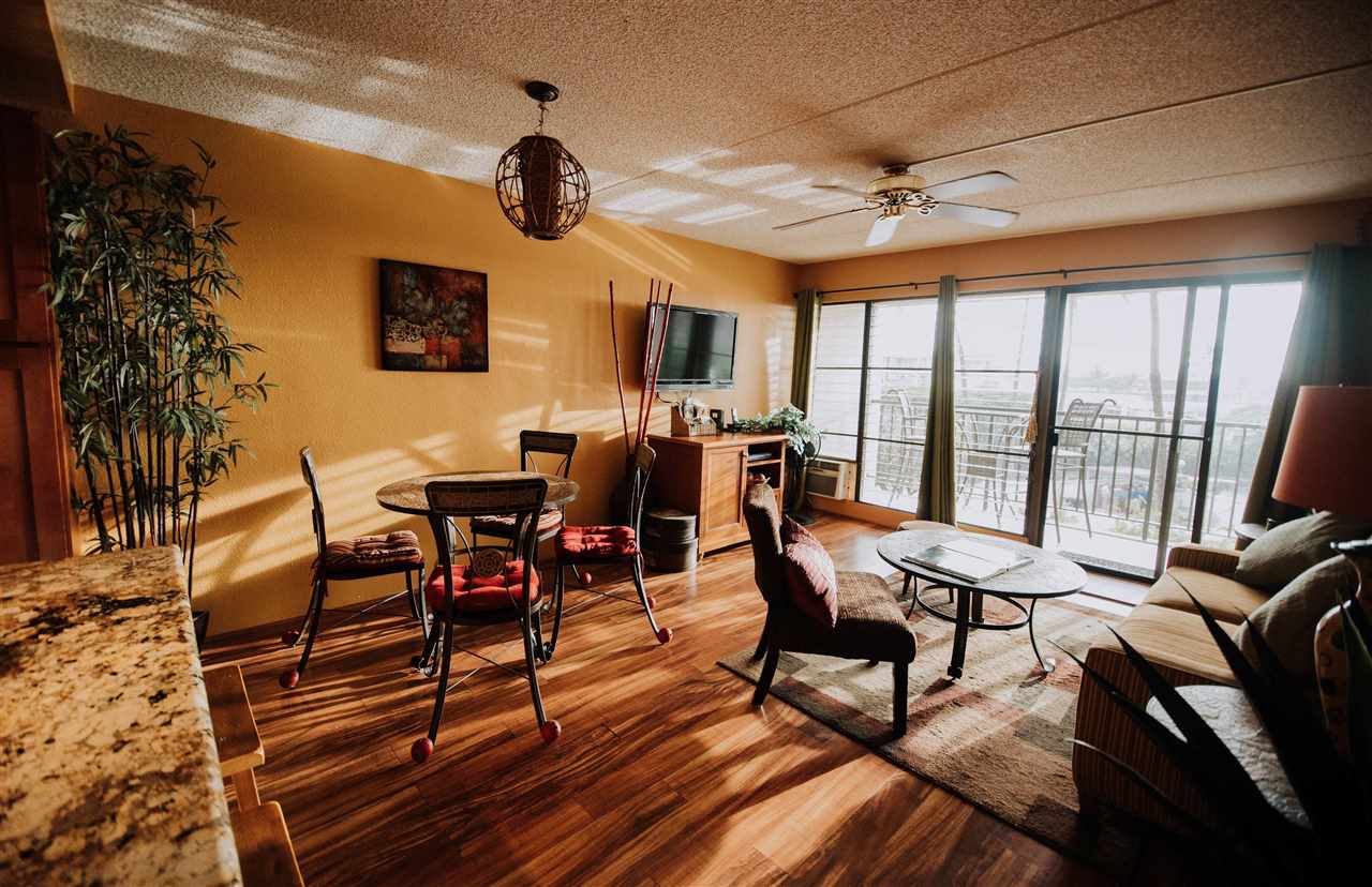 2531 South Kihei Road, Unit D210 Kihei, HI 96753 - Photo 8 of 23 a living room with furniture a flat screen tv and a large window