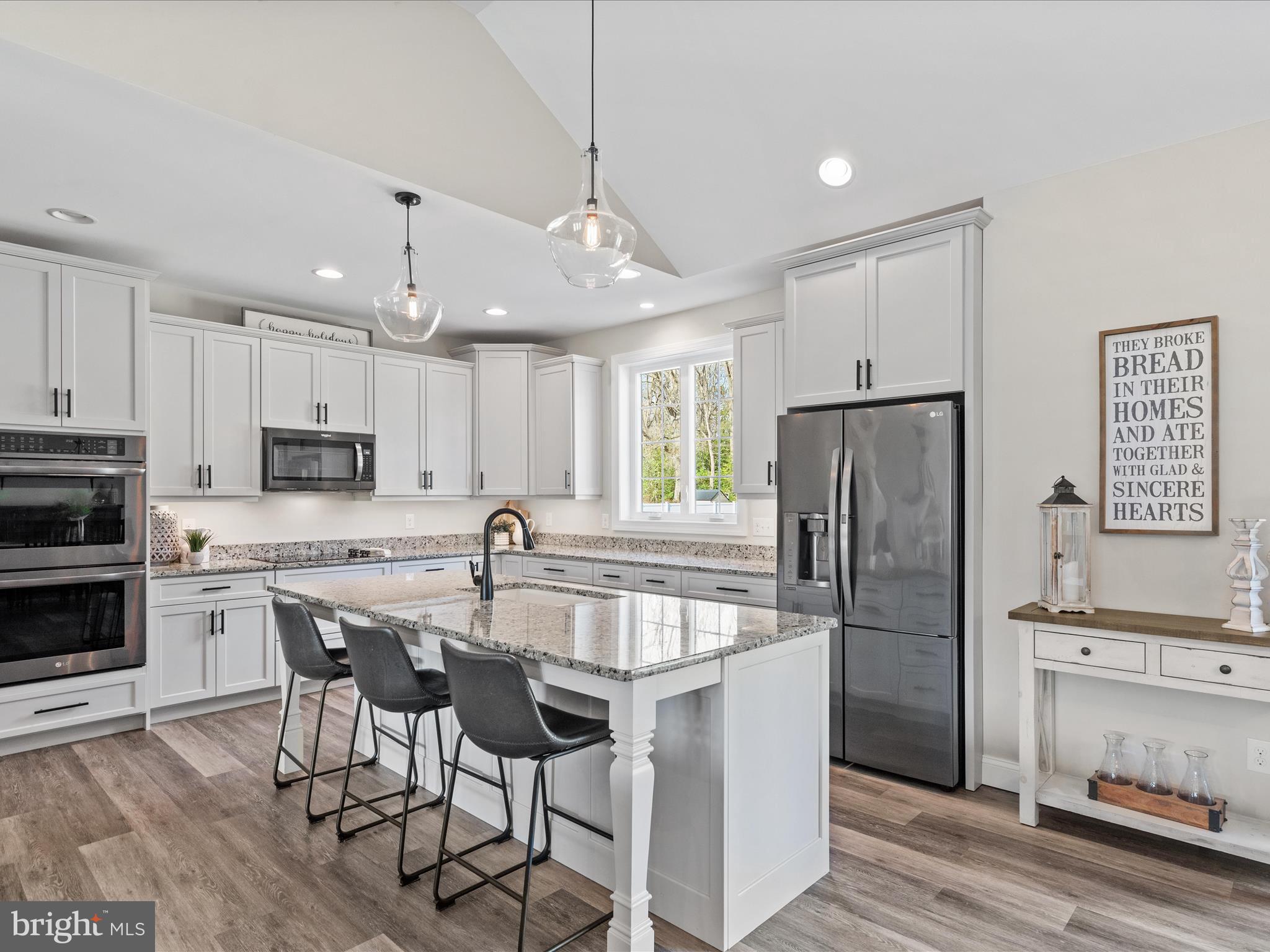 20355 Cool Spring Road Milton, DE 19968 - Photo 12 of 54 a kitchen with stainless steel appliances granite countertop a refrigerator a stove a sink a dining table and chairs with wooden floor