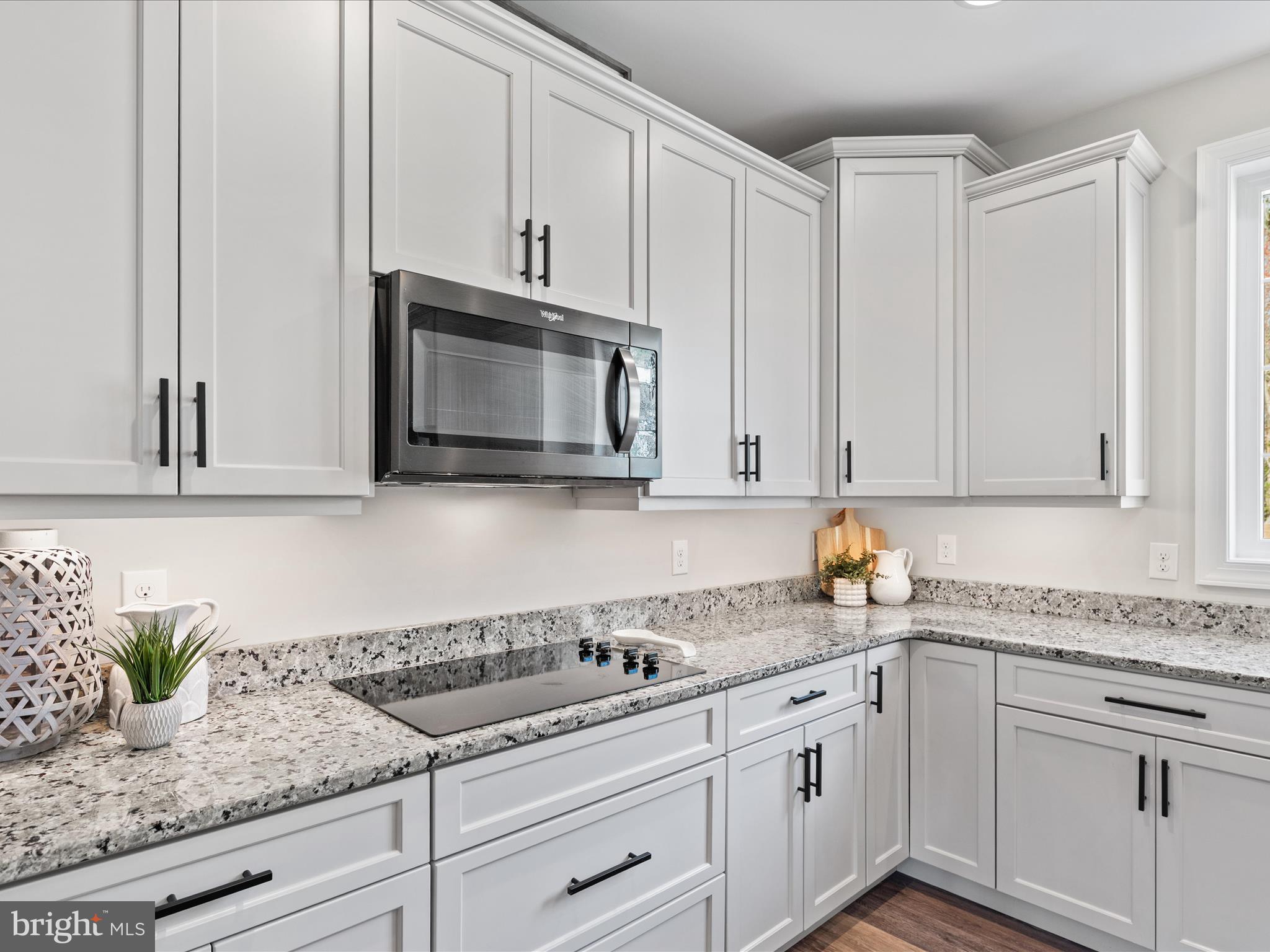 20355 Cool Spring Road Milton, DE 19968 - Photo 14 of 54 a kitchen with granite countertop white cabinets and white appliances