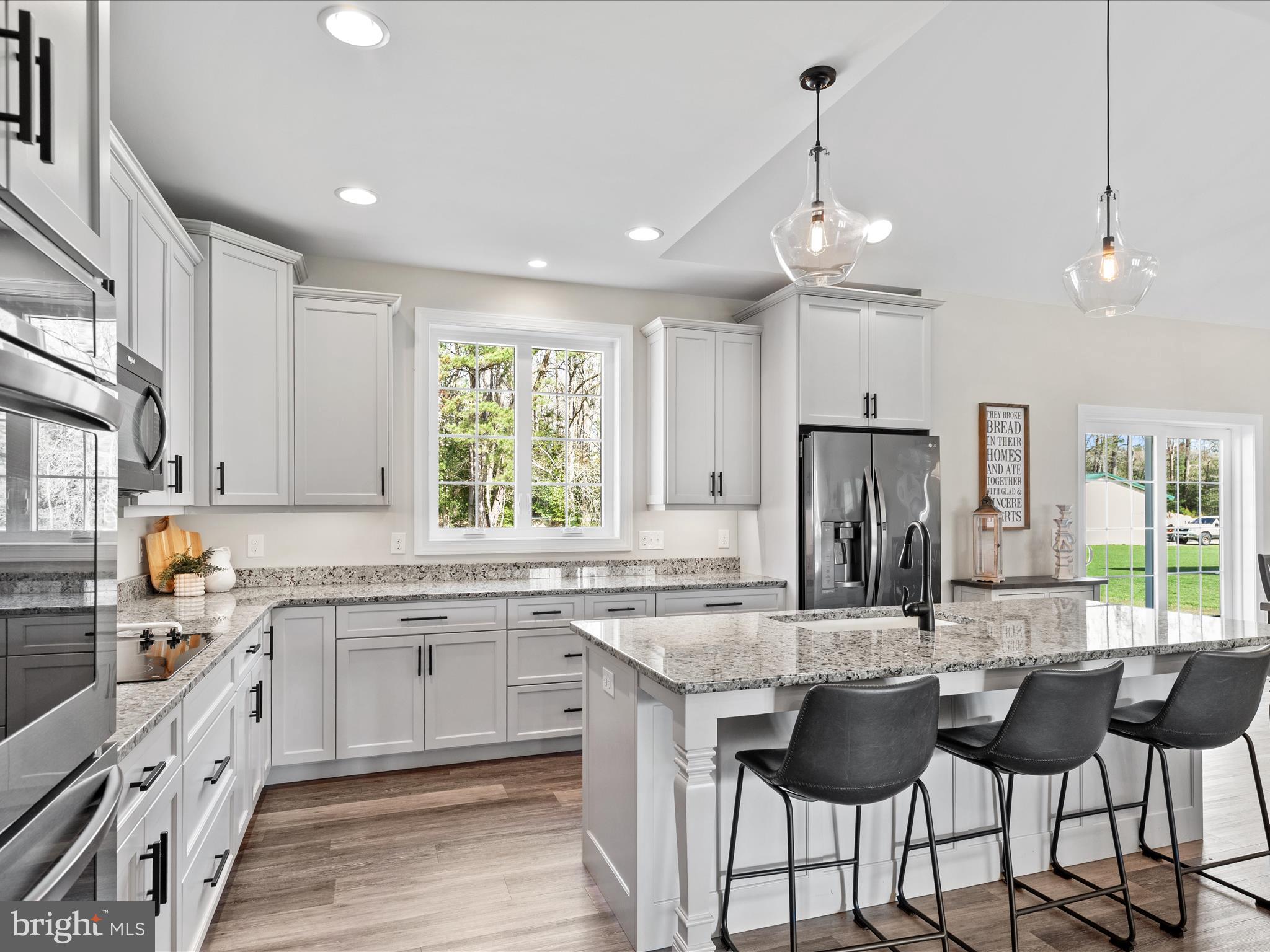 20355 Cool Spring Road Milton, DE 19968 - Photo 17 of 54 a kitchen with granite countertop a sink and refrigerator