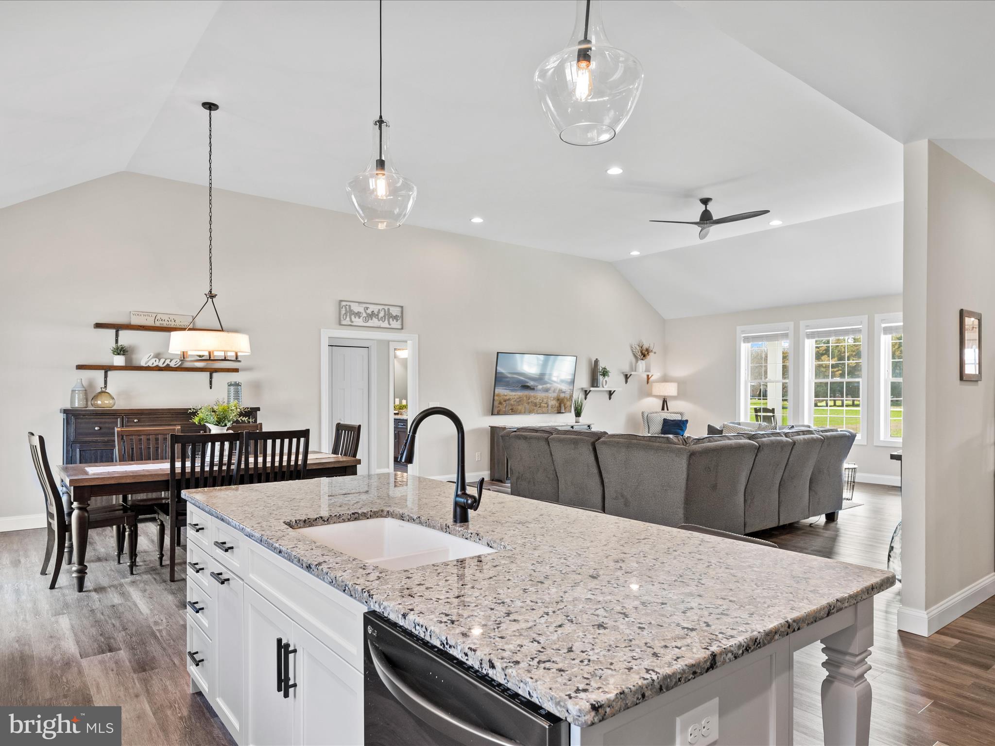 20355 Cool Spring Road Milton, DE 19968 - Photo 18 of 54 a kitchen with a stove a kitchen island a dining table and chairs