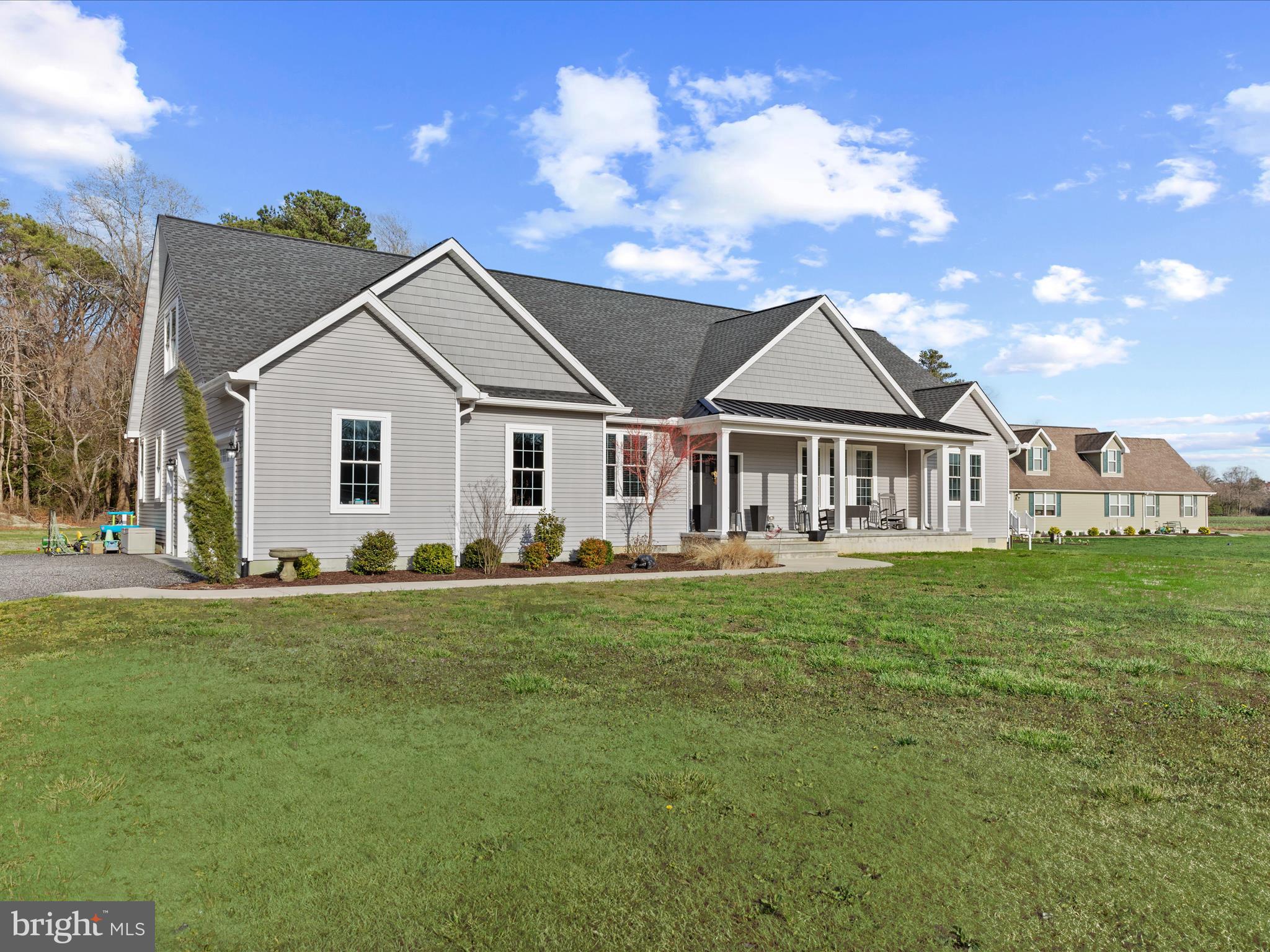 20355 Cool Spring Road Milton, DE 19968 - Photo 2 of 54 a front view of a house with a garden