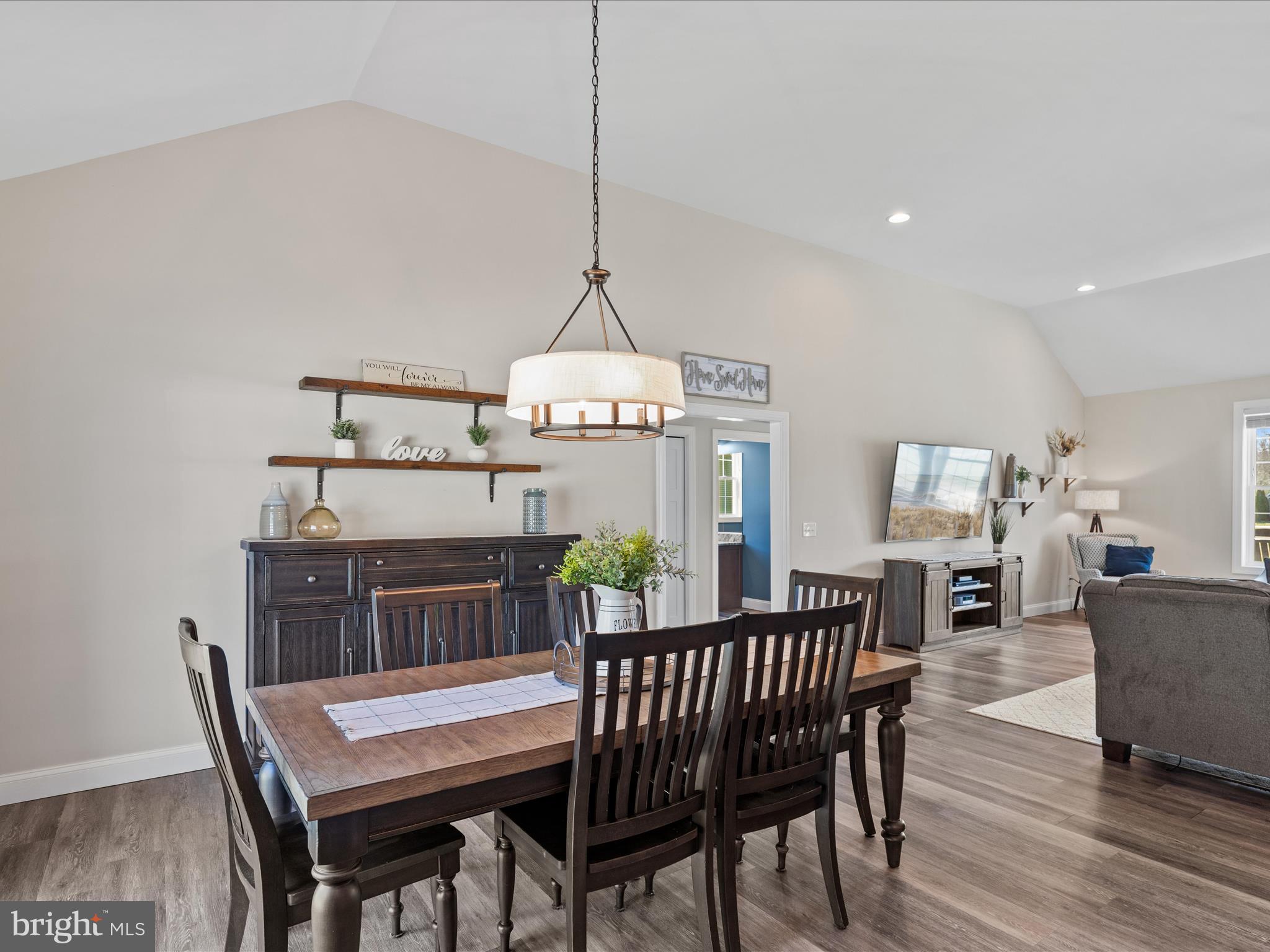 20355 Cool Spring Road Milton, DE 19968 - Photo 23 of 54 a dining room with furniture a chandelier and wooden floor
