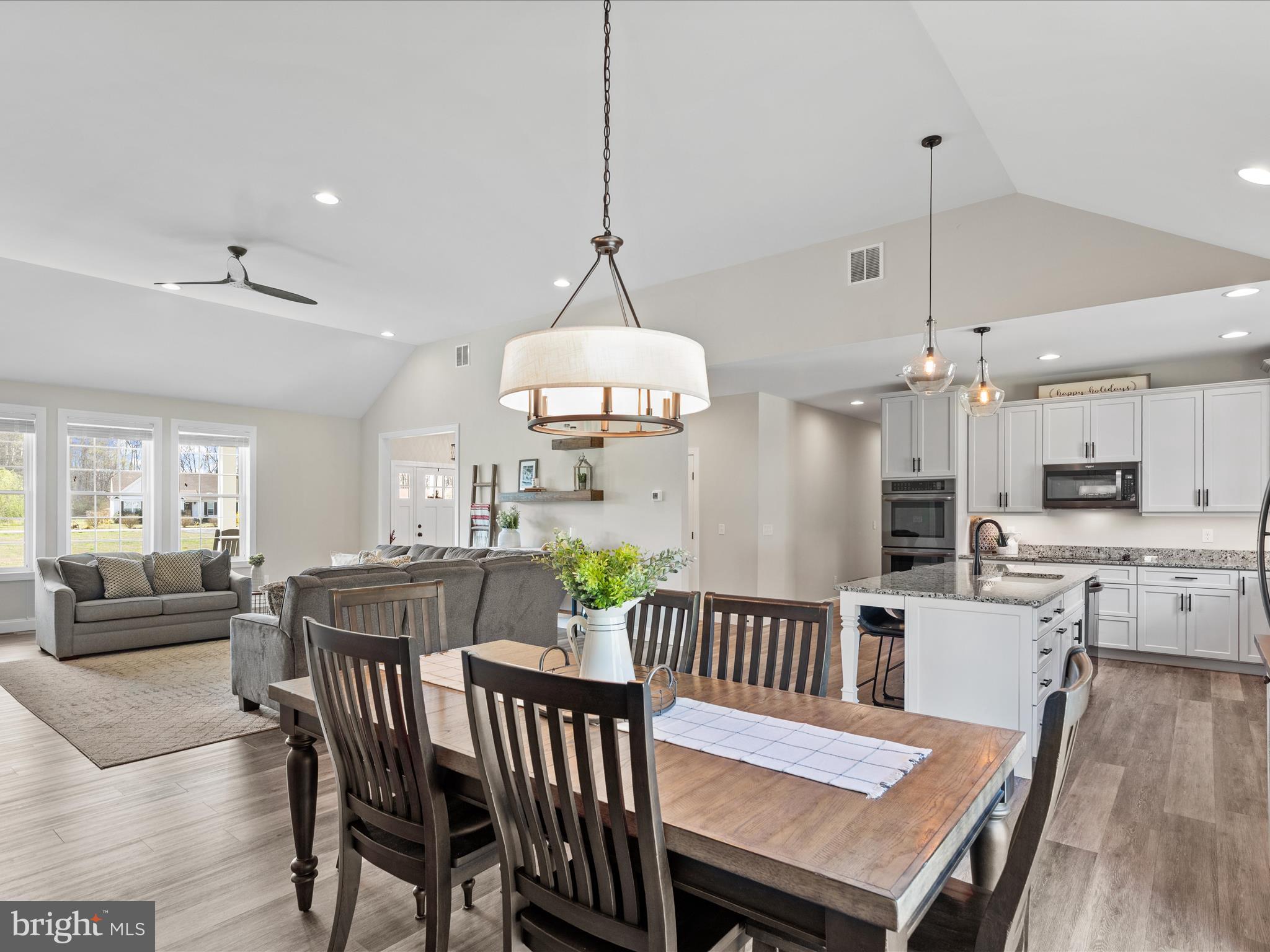 20355 Cool Spring Road Milton, DE 19968 - Photo 25 of 54 a view of a dining room and livingroom with furniture wooden floor a chandelier