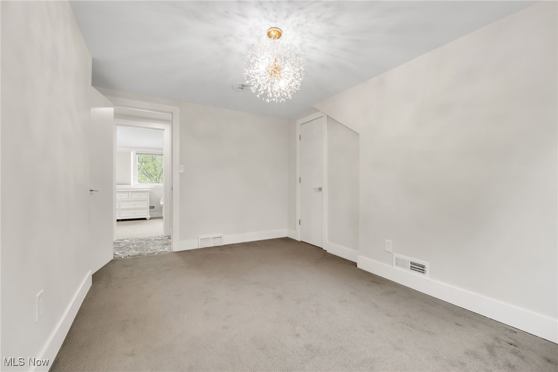 2524 Claver Road Cleveland, OH 44118 - Photo 39 of 50 Unfurnished room with a chandelier, carpet floors, and baseboards
