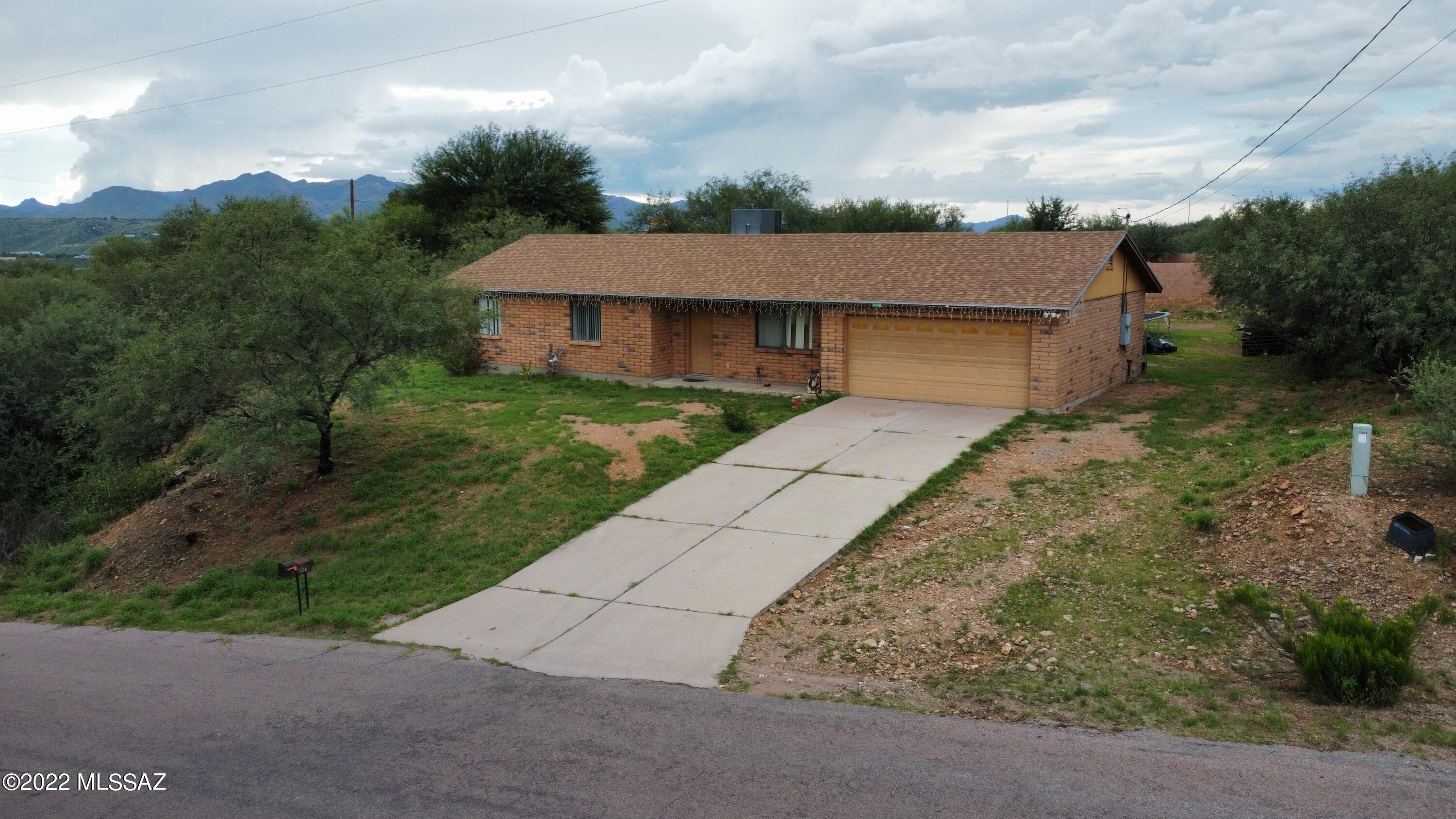 250 Camino Apolena Rio Rico, AZ 85648 - Photo 1 of 13 front view of a house with a yard