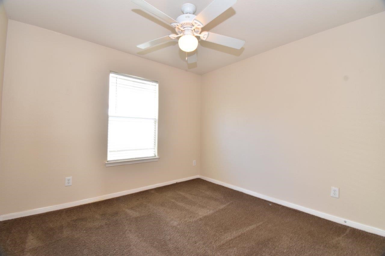 1126 Desert Oasis Lane Rosenberg, TX 77471 - Photo 11 of 16 an empty room with a window and a fan