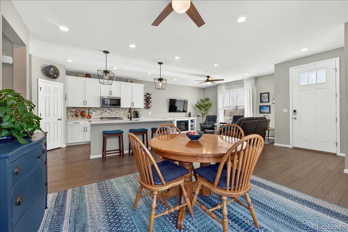 9793 Banner Peak Loop Littleton, CO 80125 - Photo 17 of 42 a view of a dining area with furniture and wooden floor