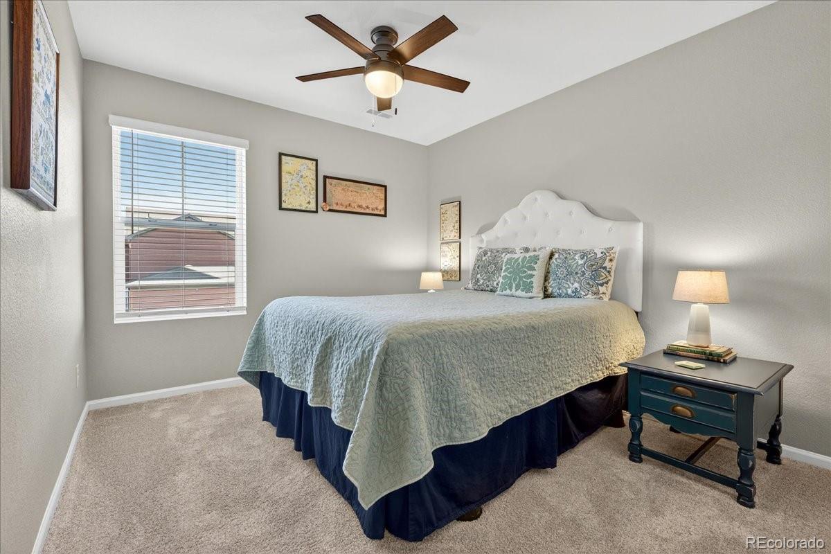 9793 Banner Peak Loop Littleton, CO 80125 - Photo 22 of 42 a bedroom with a bed and a window