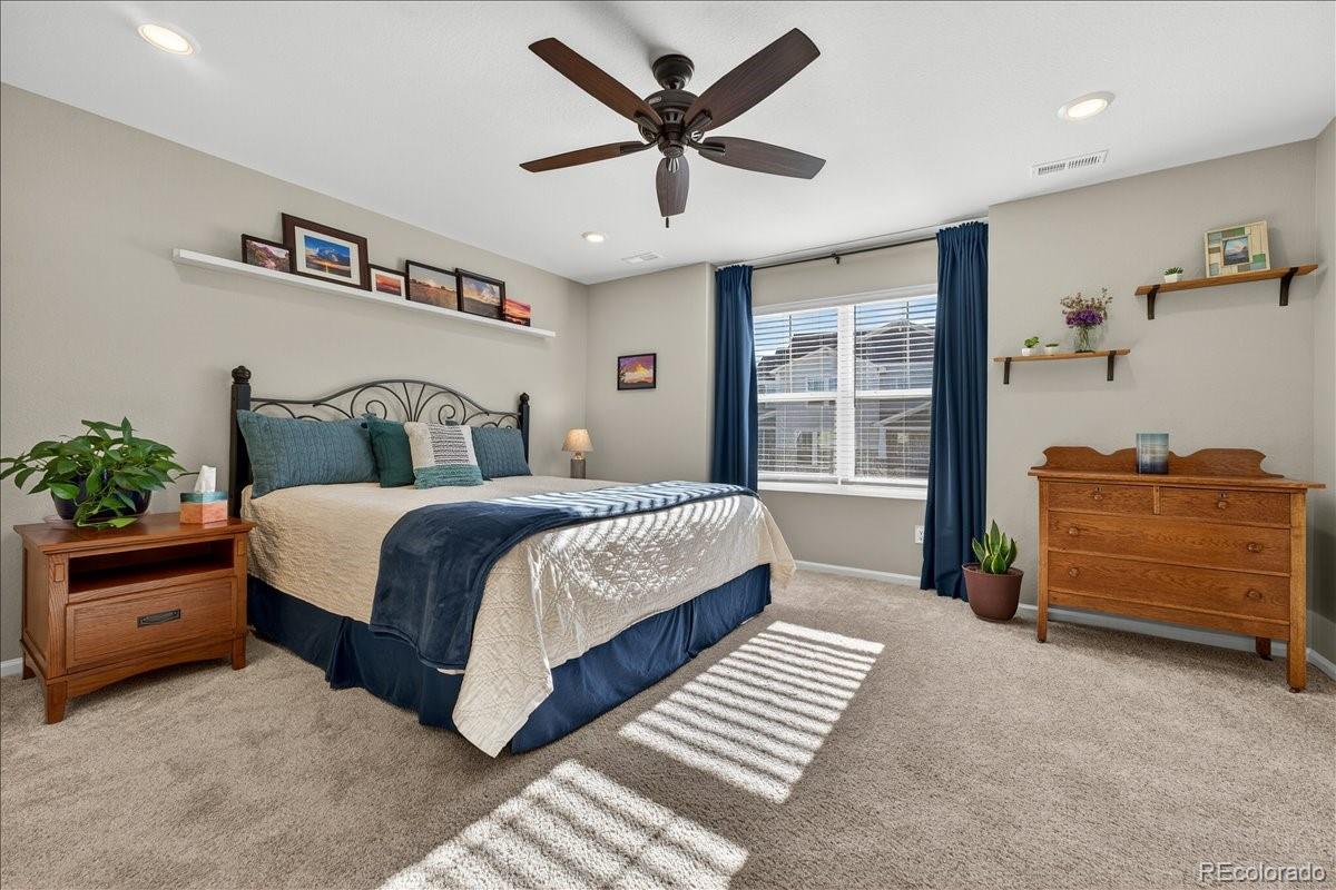 9793 Banner Peak Loop Littleton, CO 80125 - Photo 8 of 42 a bedroom with a bed and a window