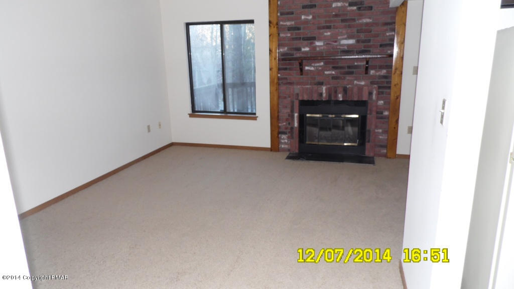 216 Falls Circle Bushkill, PA 18324 - Photo 2 of 11 a view of an empty room with a fireplace