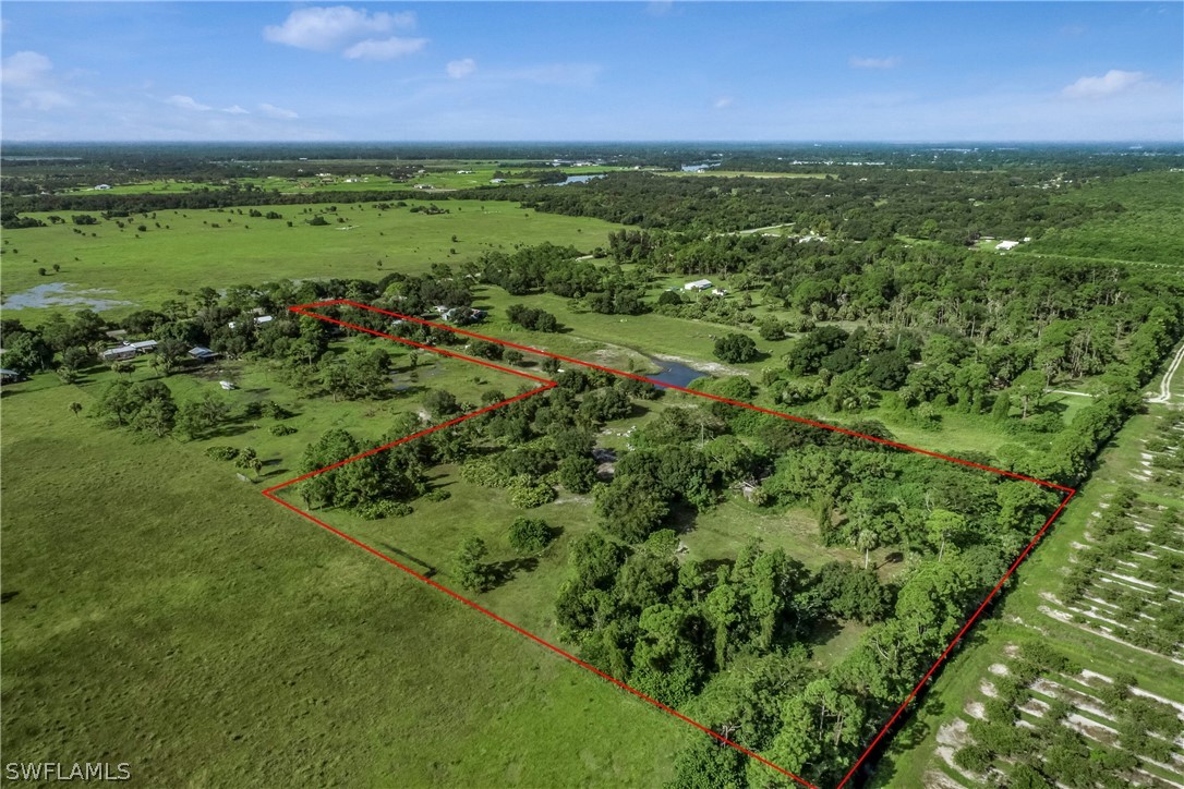 23691 North River Road Alva, FL 33920 - Photo 1 of 5 a view of a lush green outdoor space with a lake view