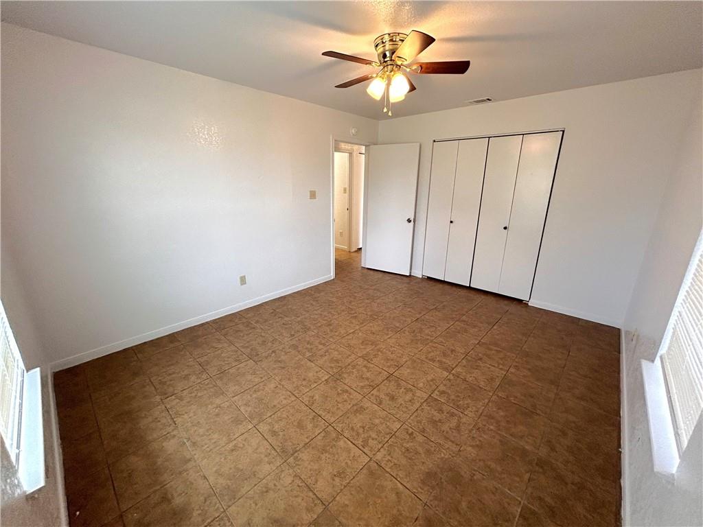 10411 Chaparral Road Killeen, TX 76548 - Photo 6 of 6 Functional bedroom featuring bi-fold closet doors and overhead ceiling fan lighting.