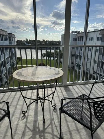 a view of a balcony with furniture